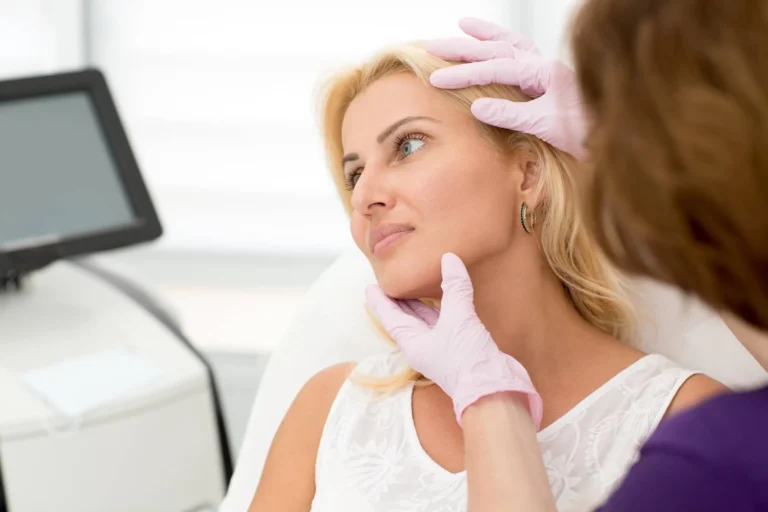 Side view of attractive woman during appointment with doctor at cosmetology office