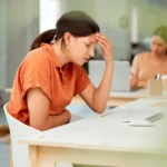 Woman in pain at her desk