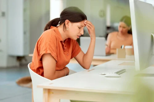 Woman in pain at her desk