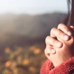 Hands placed together in faith