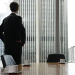 Boardroom. Single adult business man waiting for meeting to begin in Board room