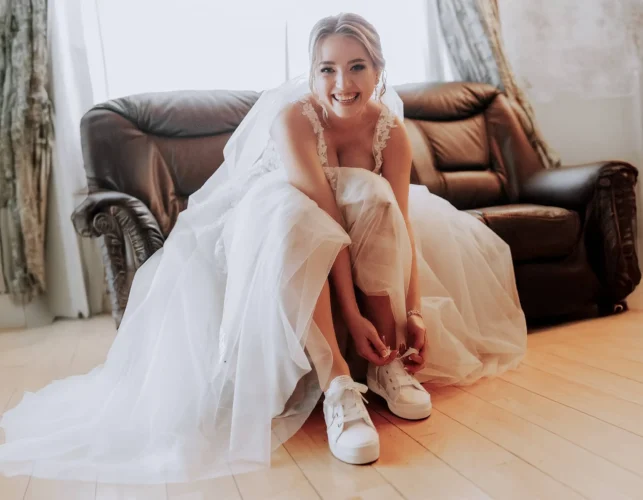 Woman wearing Wedding Dress and Sporty Shoes