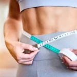Fitness, measuring and girl on flat belly from training
