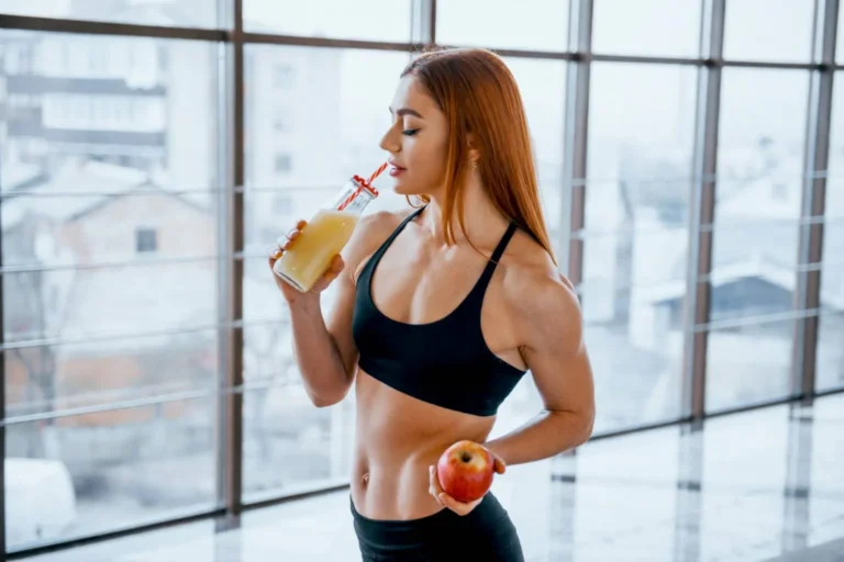 Woman drinks apple juice from bottle