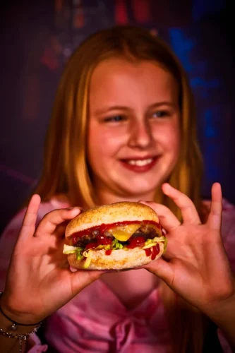 Young person holds Frankie and Benny's Burger