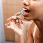 Person flosses their teeth