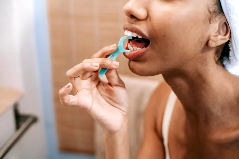 Person flosses their teeth
