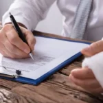 Person writes with one hand and the other hand bandaged