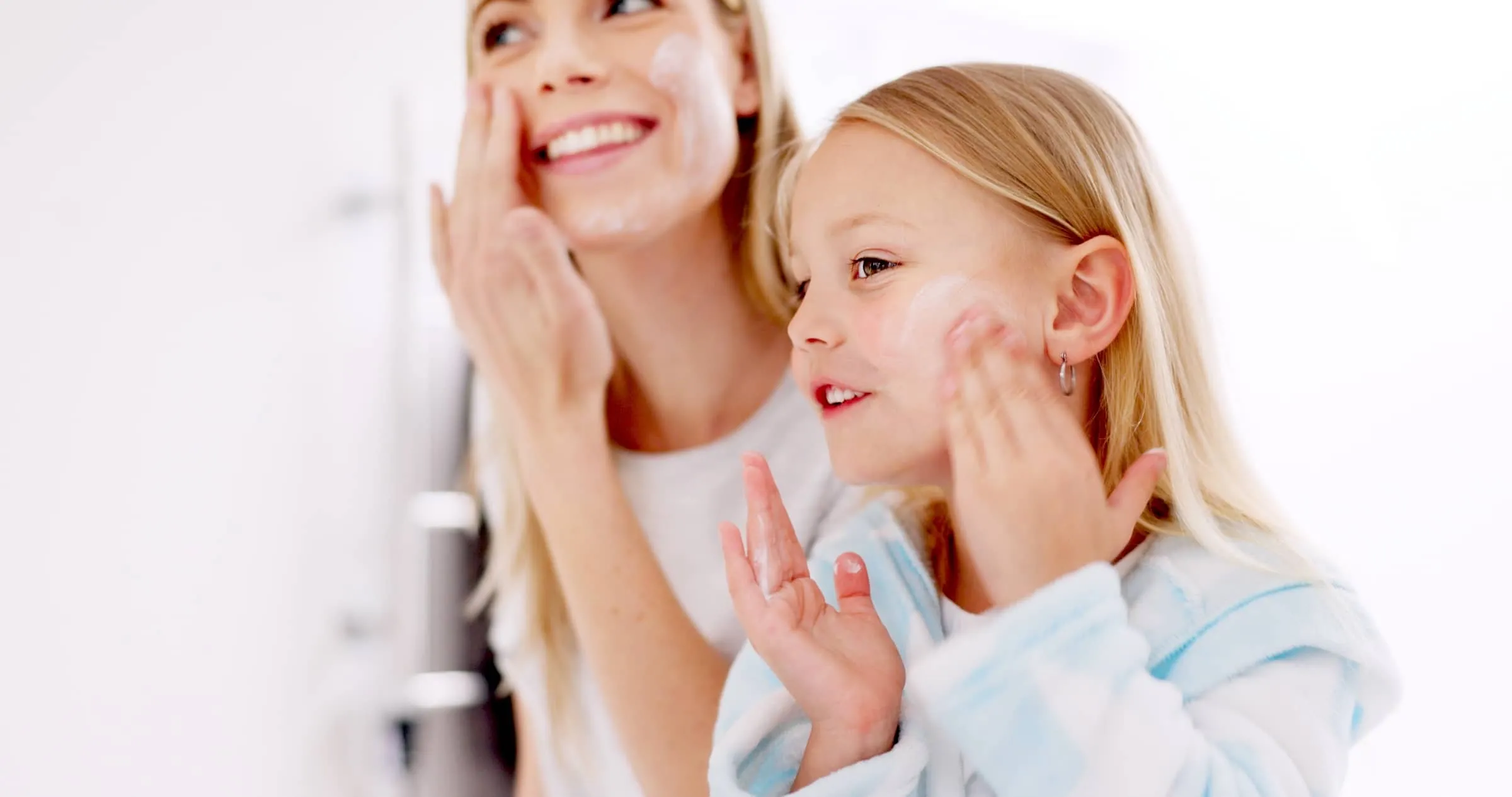 Skincare, mother and daughter home spa day washing their face in bathroom
