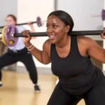Women doing barbell workout