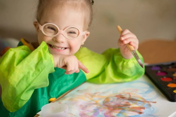 Young child smiling and painting
