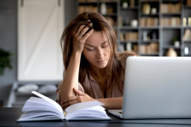 Woman tired at laptop