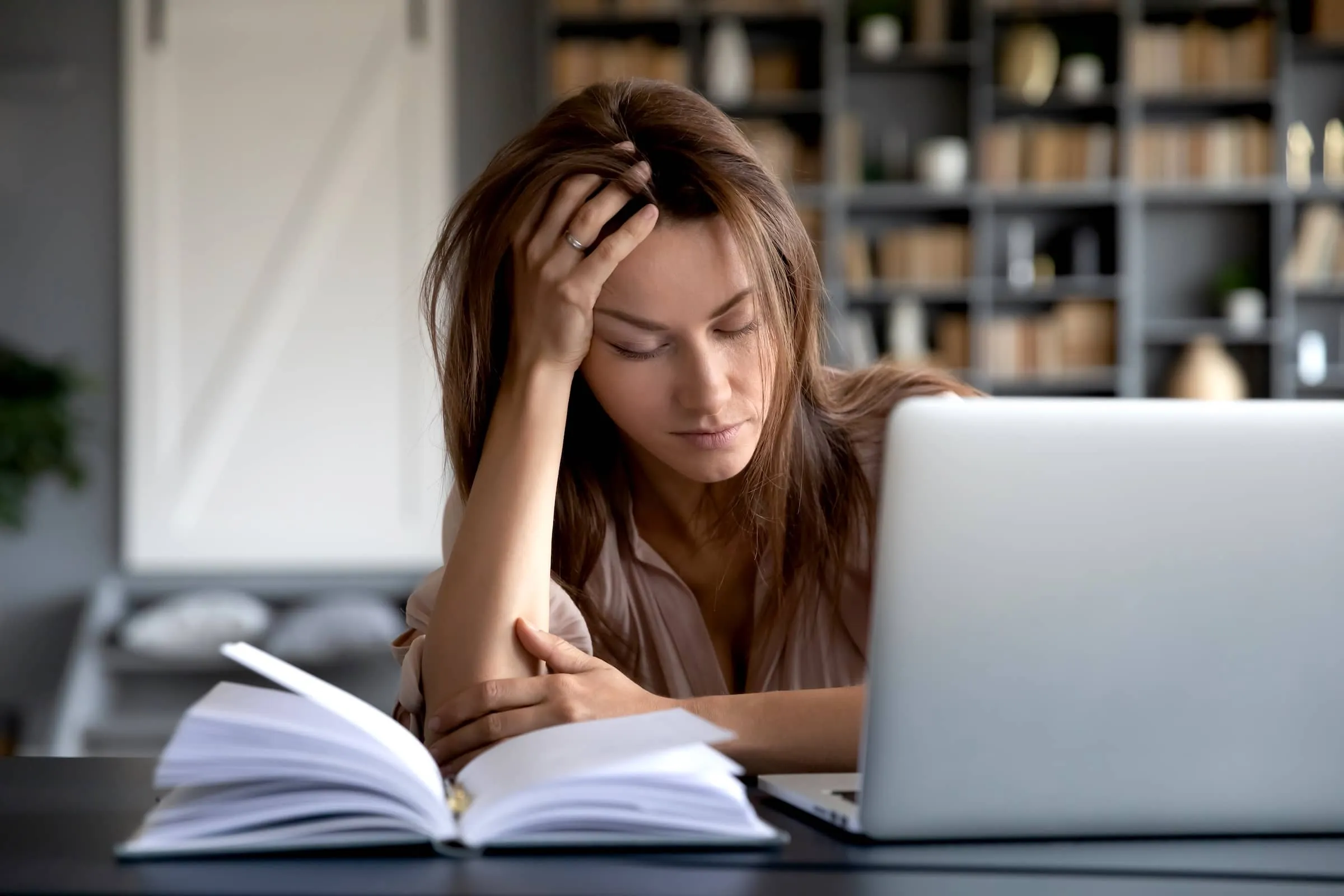 Woman tired at laptop