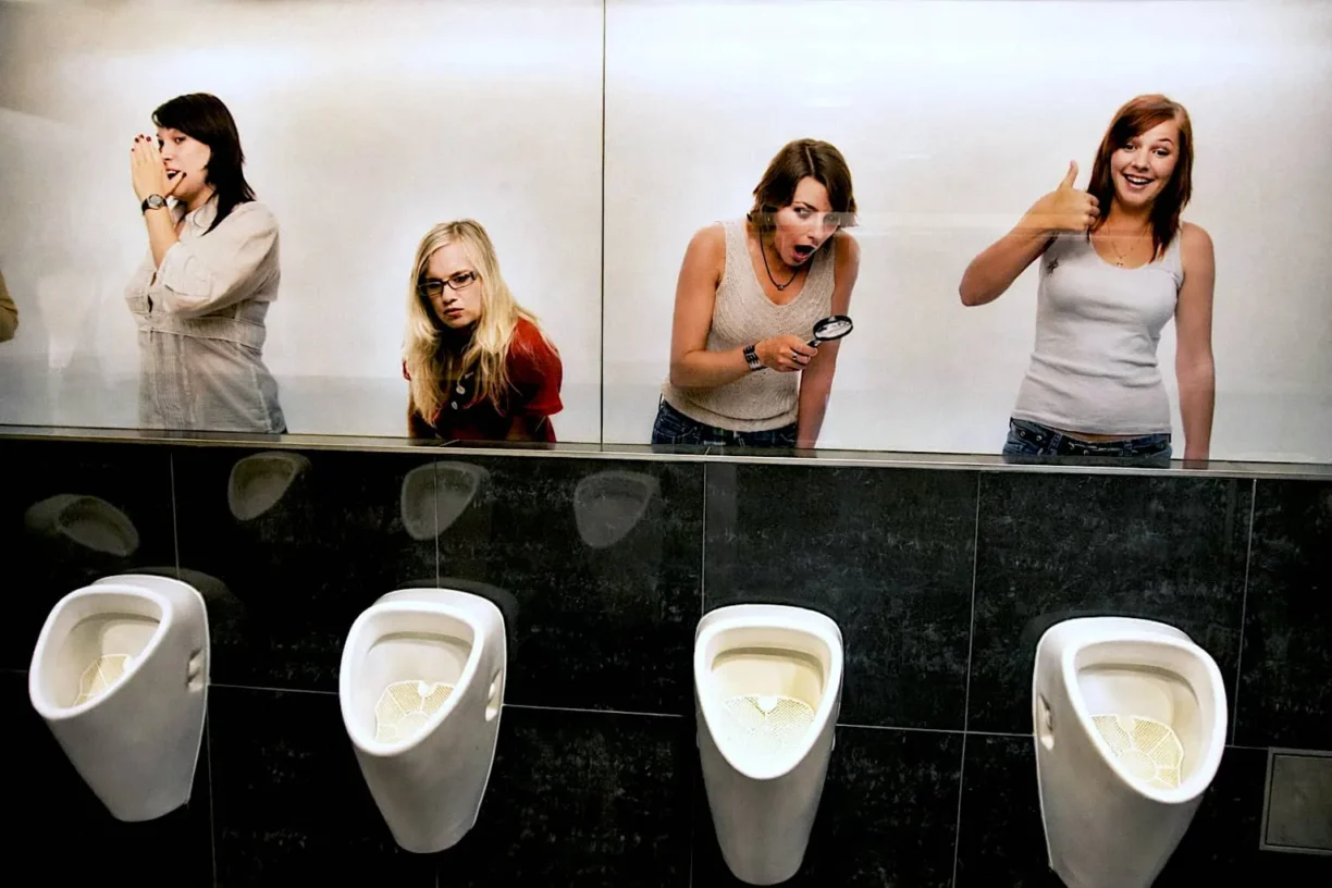 Women making fun of men in toilet