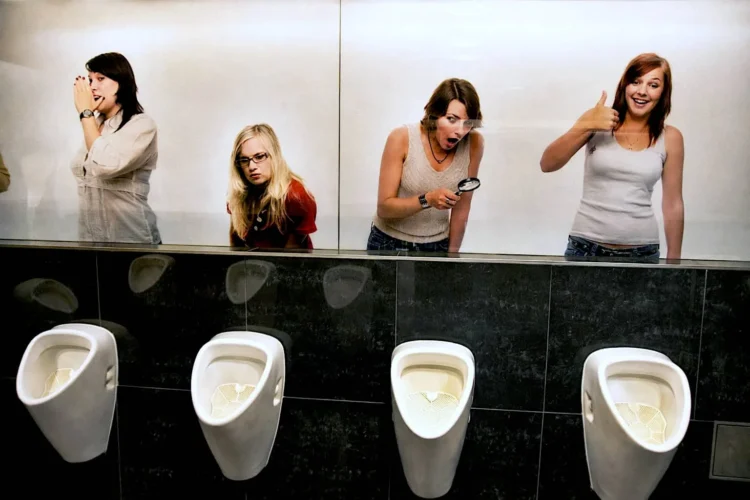 Women making fun of men in toilet