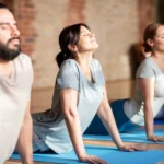 group of people doing yoga dog pose at studio