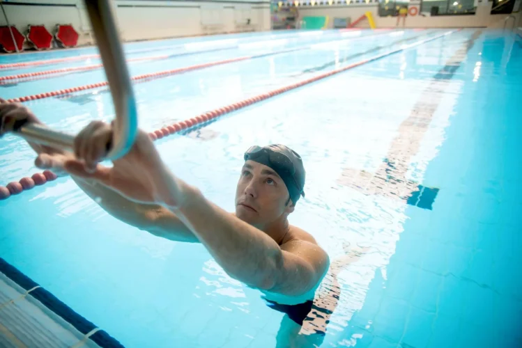 Male swimmer with swim cap in an indoor pool