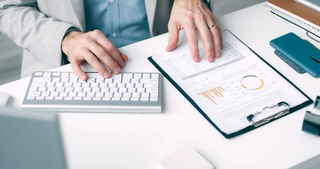 Person looking at data sheet and using keyboard