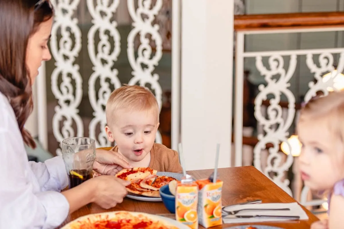 Young child looks eager to eat pizza
