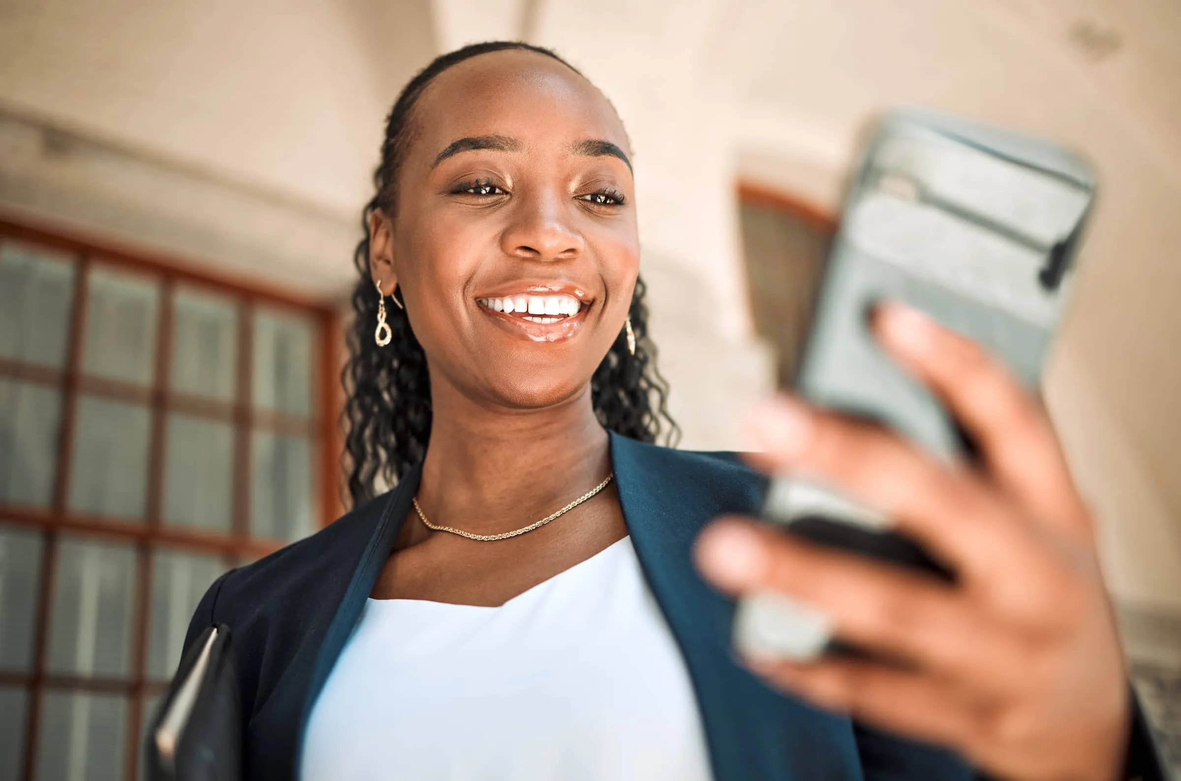 Woman with phone looks and smiles