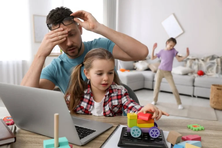 Children disturbing stressed man in living room. Working from home