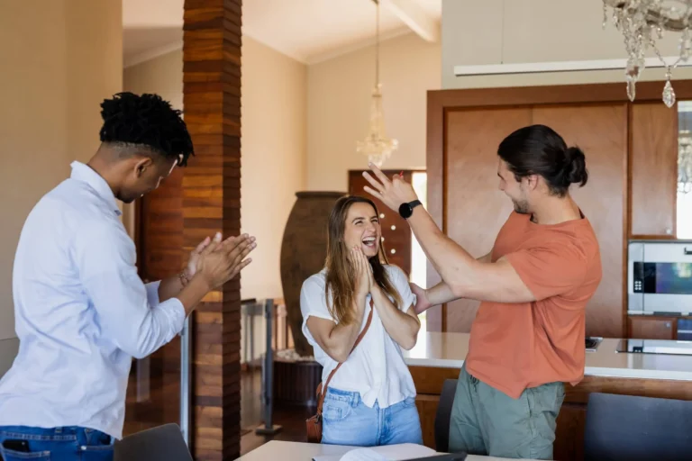 Friends celebrating success at home