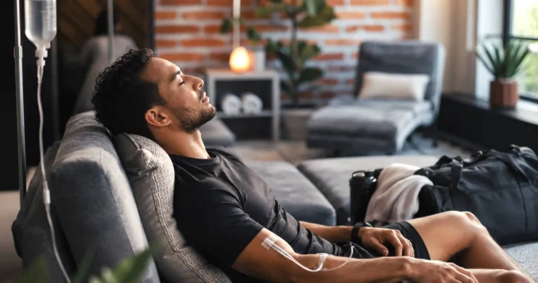 Athletic looking man and iv drip in clinic for healthcare