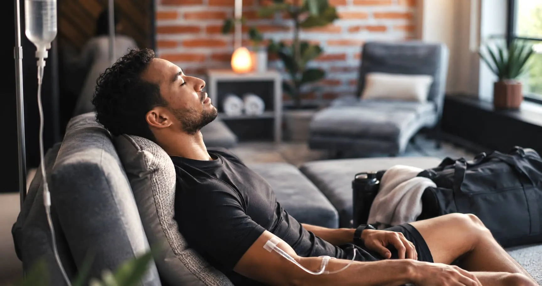 Athletic looking man and iv drip in clinic for healthcare