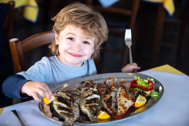 Child Eating Grilled Fish