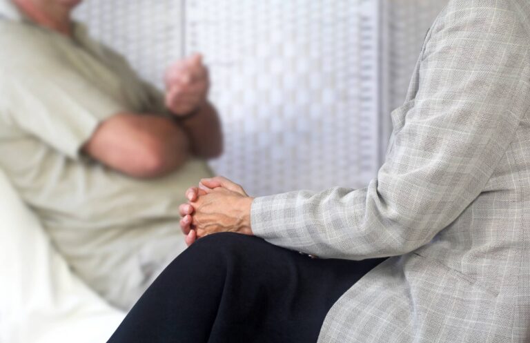 Counseling session. Counseling therapist listening to patient sat on couch