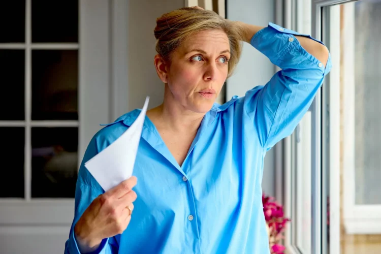 Mature Woman Having Hot Flush At Home