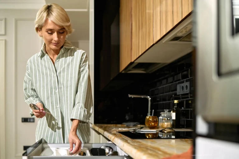 Middle Aged Woman Organizing Kitchen Utensils in Modern Home