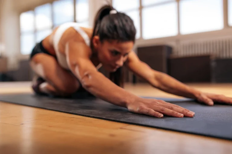 Woman doing stretching workout on fitness mat