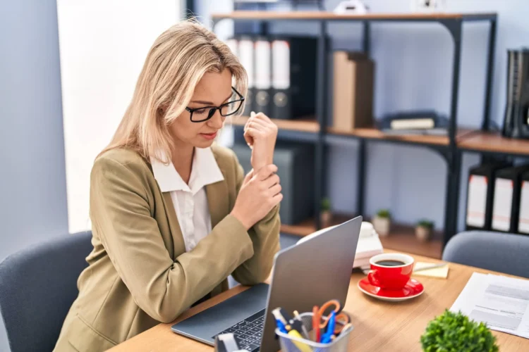 business worker suffering for wrist pain at office