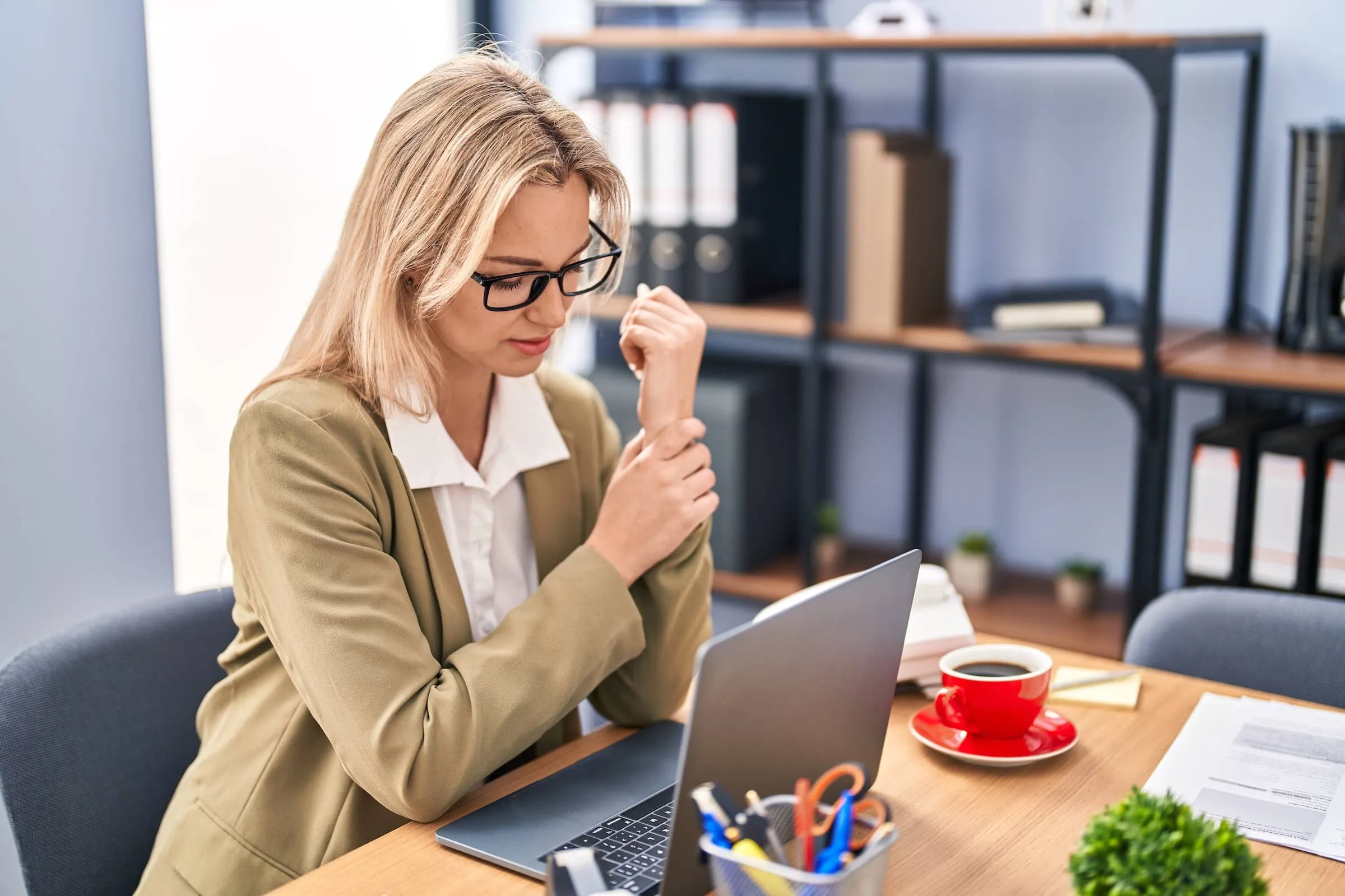 business worker suffering for wrist pain at office