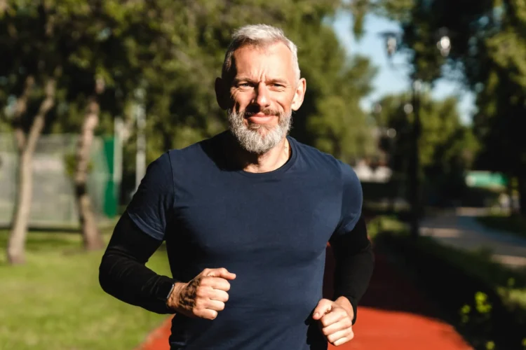 Closeup portrait of a male mature athlete sportsman runner jogging