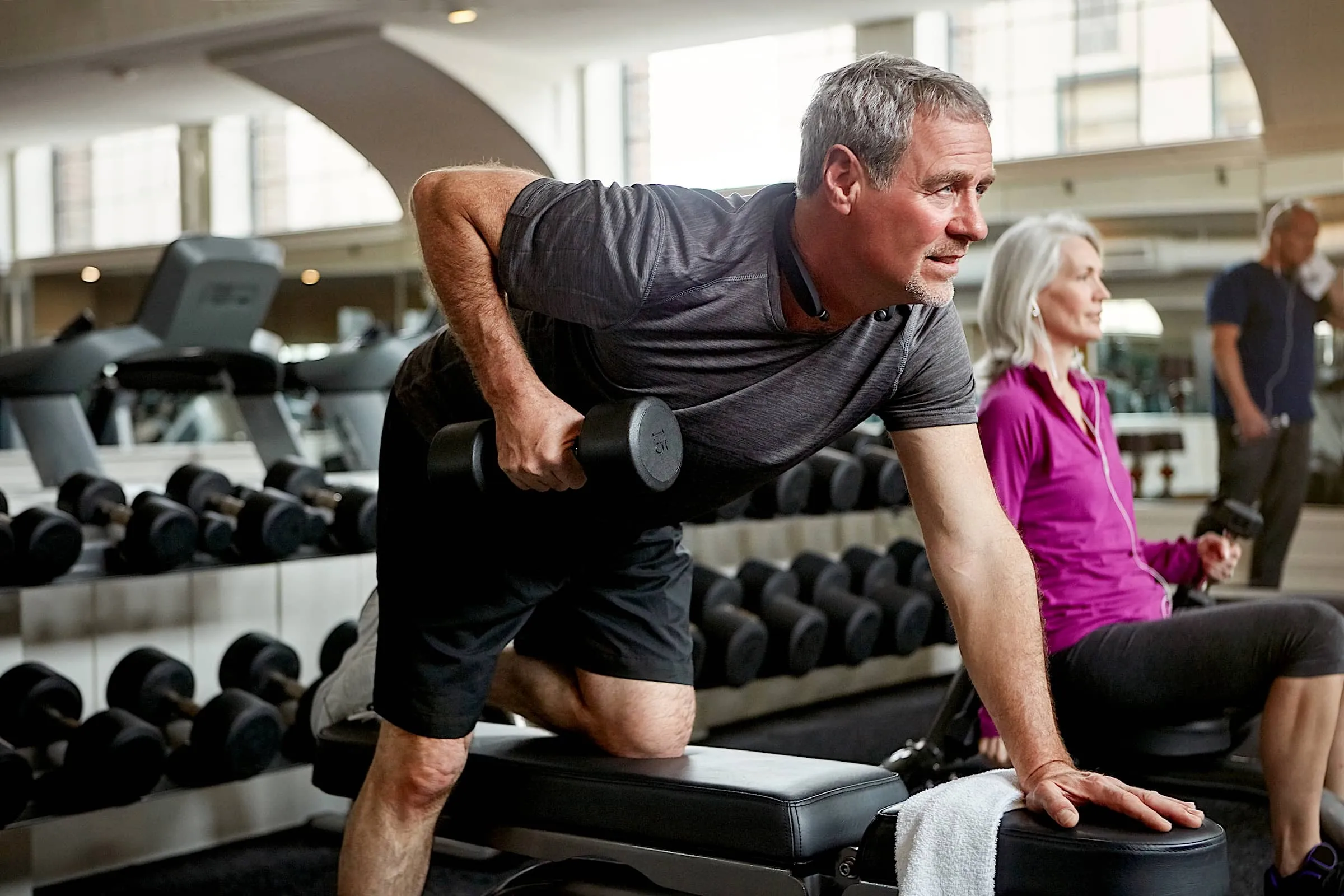 Fitness, weights and senior man in gym for workout, training and cardio exercise for healthy body