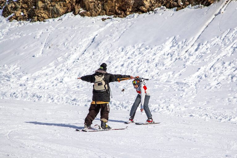 Ski resort, instructor is teaching a young girl to ski, Opening of the ski season