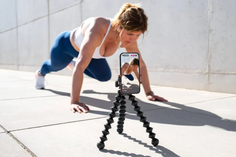 Woman films herself on mobile phone and live streaming her fitness workout on social media