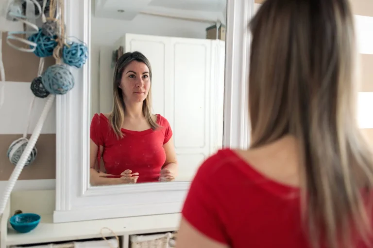 Woman looking at herself in mirror