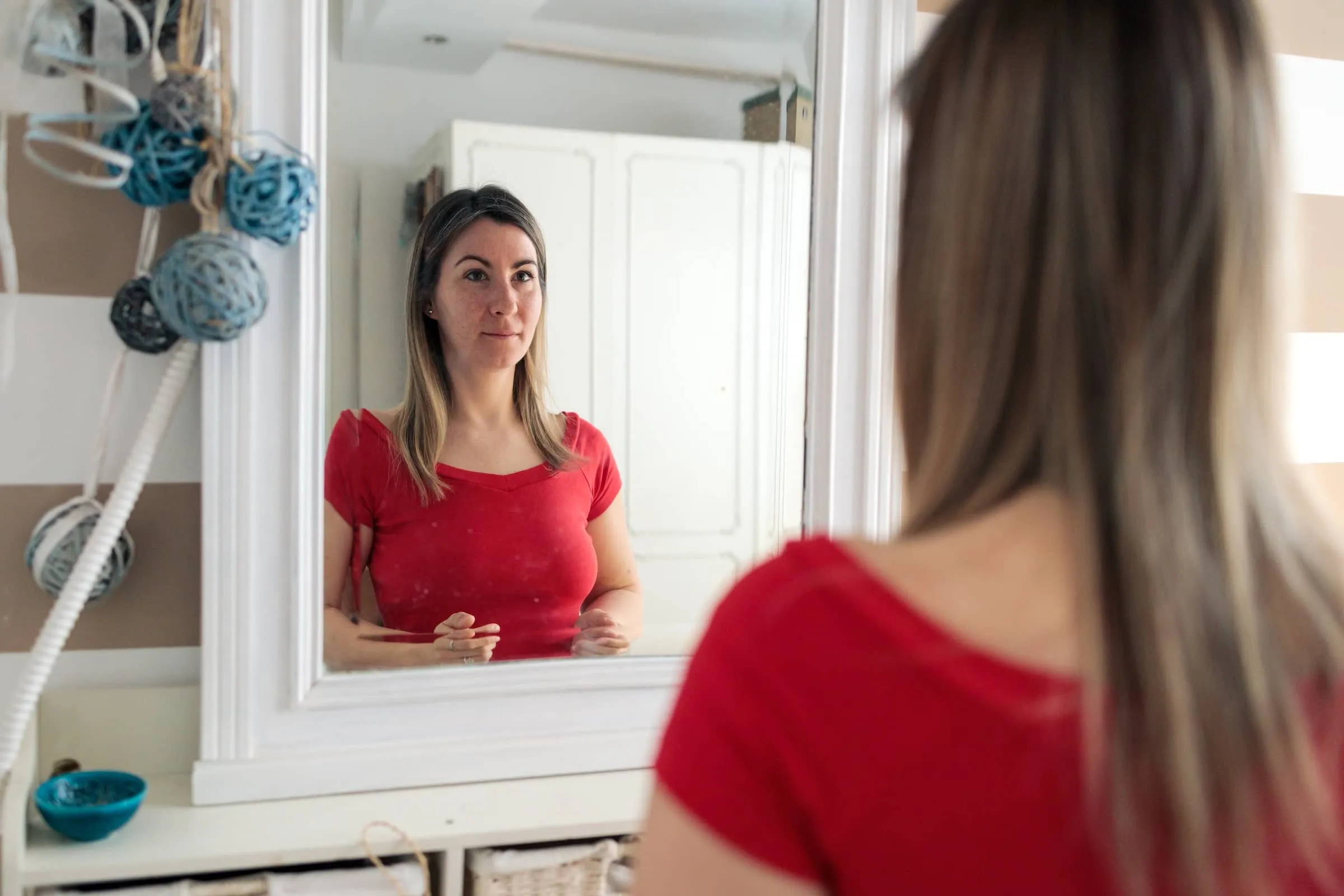 Woman looking at herself in mirror