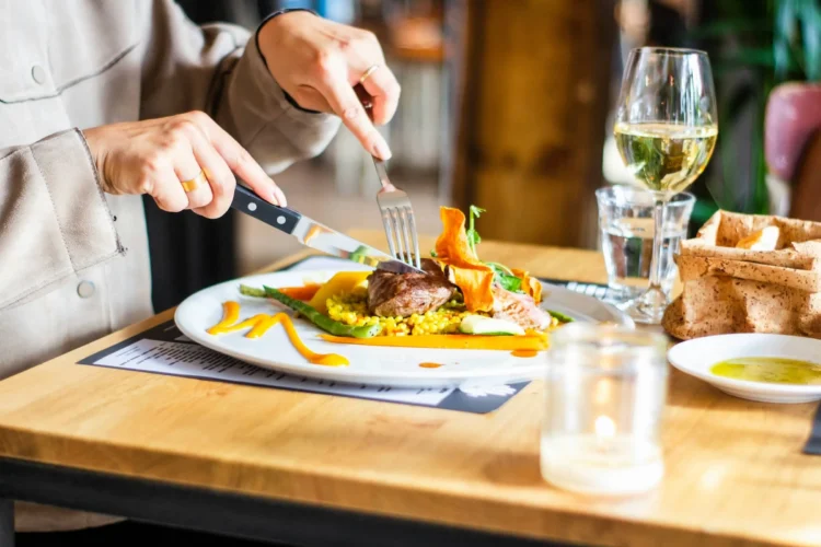person eating food at dining table