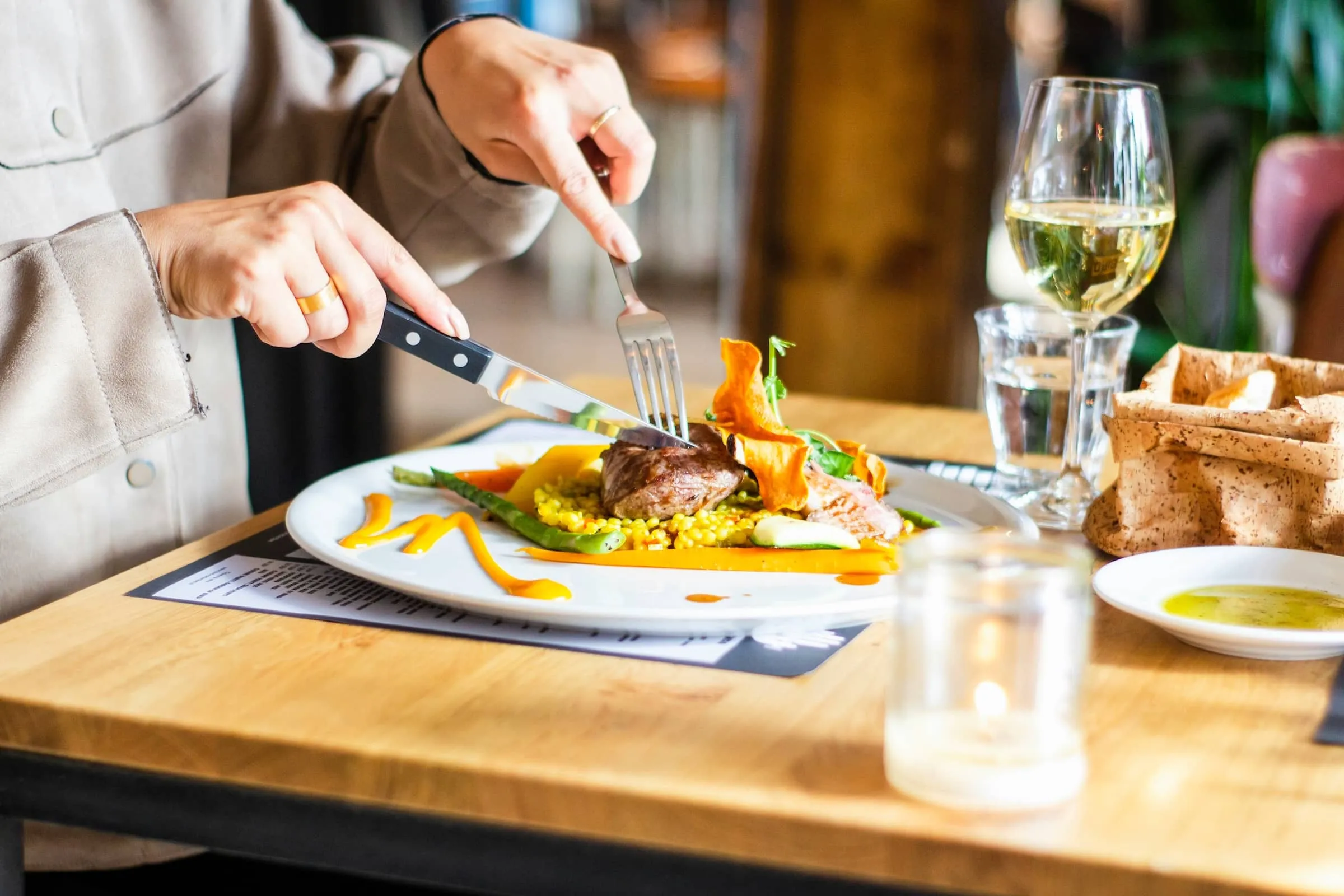 person eating food at dining table